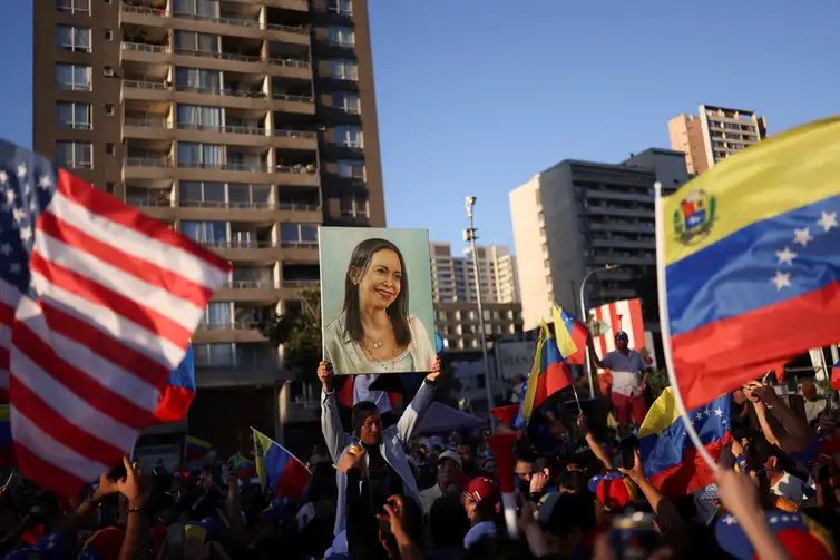 REUTERS/Pablo Sanhueza/Proibida reprodução Manifestante segura cartaz com a imagem da líder da oposição venezuelana María Corina Machado durante manifestação em Santiago
03/01/2026 REUTERS/Pablo Sanhueza