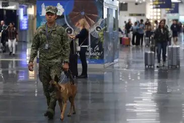 A member of the Mexican Navy K9 unit patrols Benito Juarez International Airport after authorities reinforced security following roadblocks and arson attacks carried out by organized crime in several states, after a military operation in which a government source said Mexican drug lord Nemesio Oseguera, known as “El Mencho,” was killed in Jalisco state, in Mexico City, Mexico, February 22, 2026. REUTERS/Luis Cortes